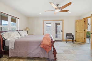 Bedroom with light stone finish floors, ceiling fan, access to exterior, and recessed lighting
