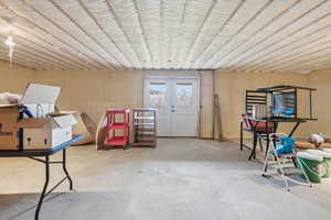 Below grade area featuring french doors