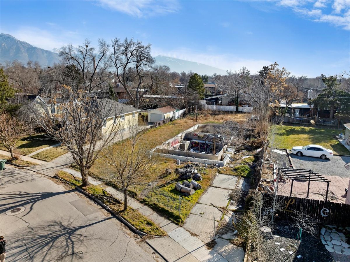 Aerial view of residential area featuring a mountainous background