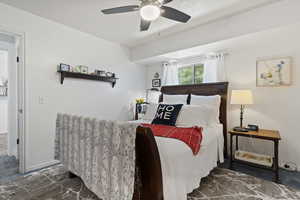 Bedroom featuring ceiling fan and marble finish flooring