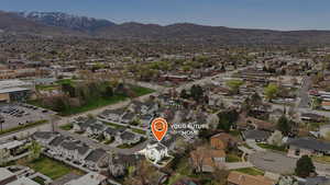 Aerial perspective of suburban area with a mountainous background