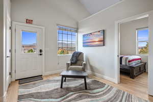 Sitting room featuring light wood finished floors and lofted ceiling