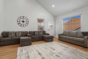 Living area featuring lofted ceiling and light wood-type flooring