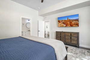 Bedroom with a ceiling fan and ensuite bathroom