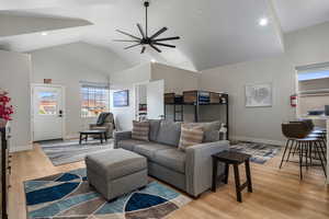 Living room featuring light wood-style flooring, recessed lighting, ceiling fan, and lofted ceiling