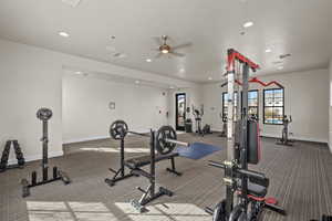 Workout area with a ceiling fan and recessed lighting