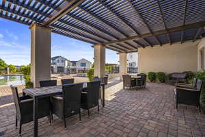 View of patio / terrace with outdoor dining area, a pergola, and a residential view
