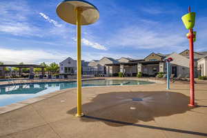 Community pool with a patio and a pergola