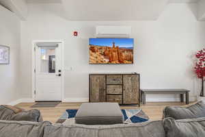 Living area featuring wood finished floors and a mini split for heating / cooling