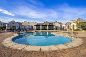 Community pool featuring a patio and a residential view