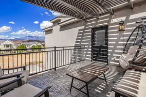 Balcony featuring a mountain view, a pergola, and a residential view