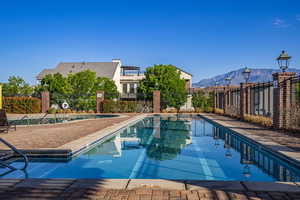 Community pool with a patio and a mountain view