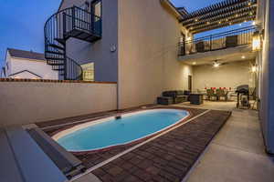 Swimming pool with a patio, outdoor seating, and grilling area