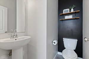 Convenient additional bathroom designed for everyday functionality on the main living level.