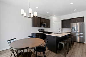 Dining area that accommodates a full size table, conveniently located just off the kitchen for everyday use.