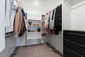 Walk-in closet within the owner’s suite providing ample storage and organization space.