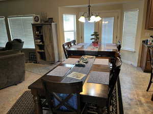 Dining room featuring hanging lights and light tile patterned flooring