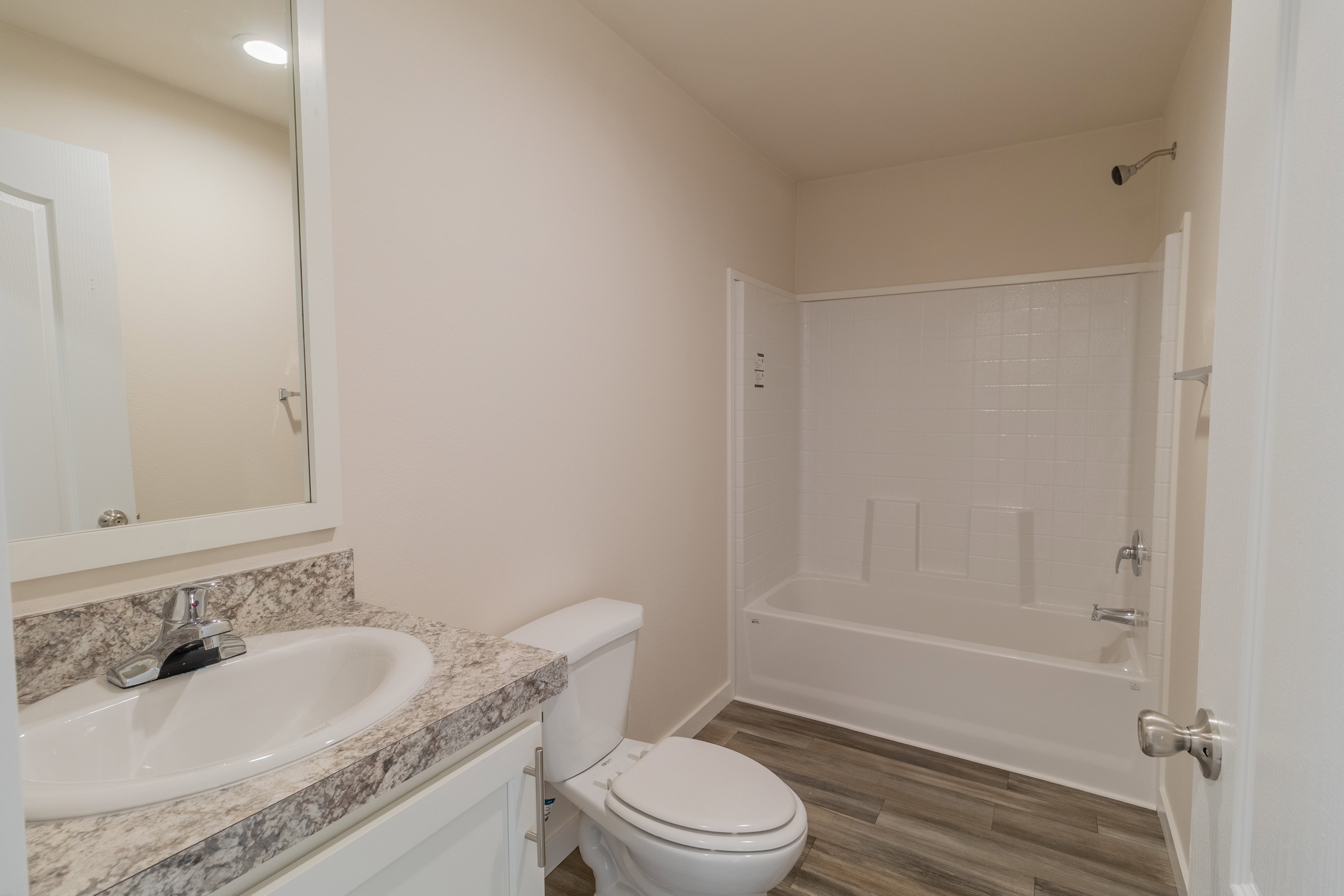 Full bath featuring vanity, dark wood-type flooring, and tub / shower combination