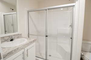 Bathroom with vanity and a shower stall
