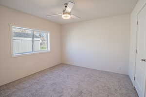 Spare room with carpet and ceiling fan