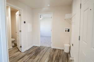 Bathroom with dark wood finished floors and a ceiling fan