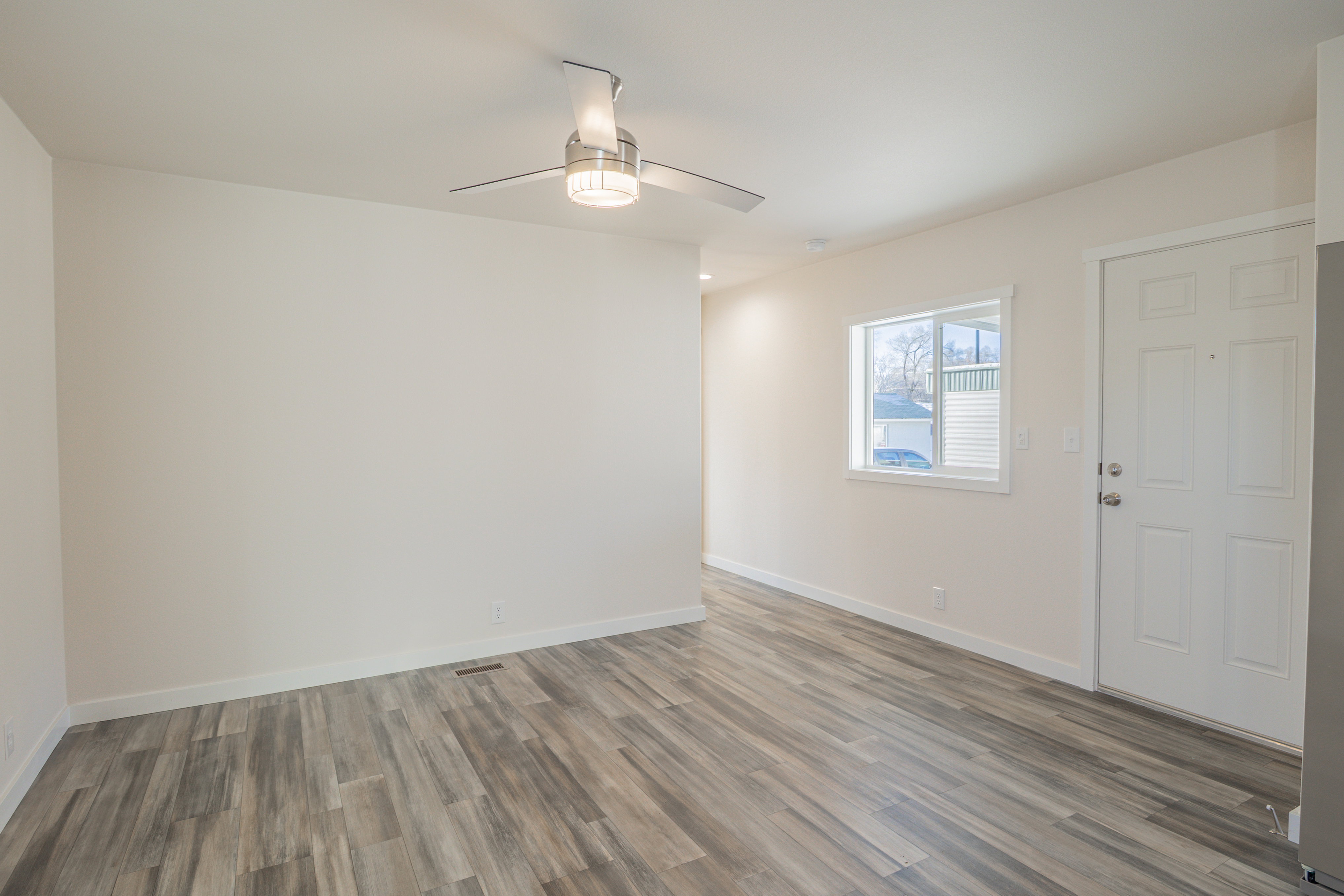 Unfurnished room featuring wood finished floors and a ceiling fan