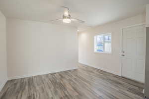 Unfurnished room featuring wood finished floors and a ceiling fan