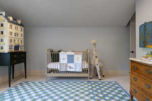 Bedroom with light carpet and baseboards