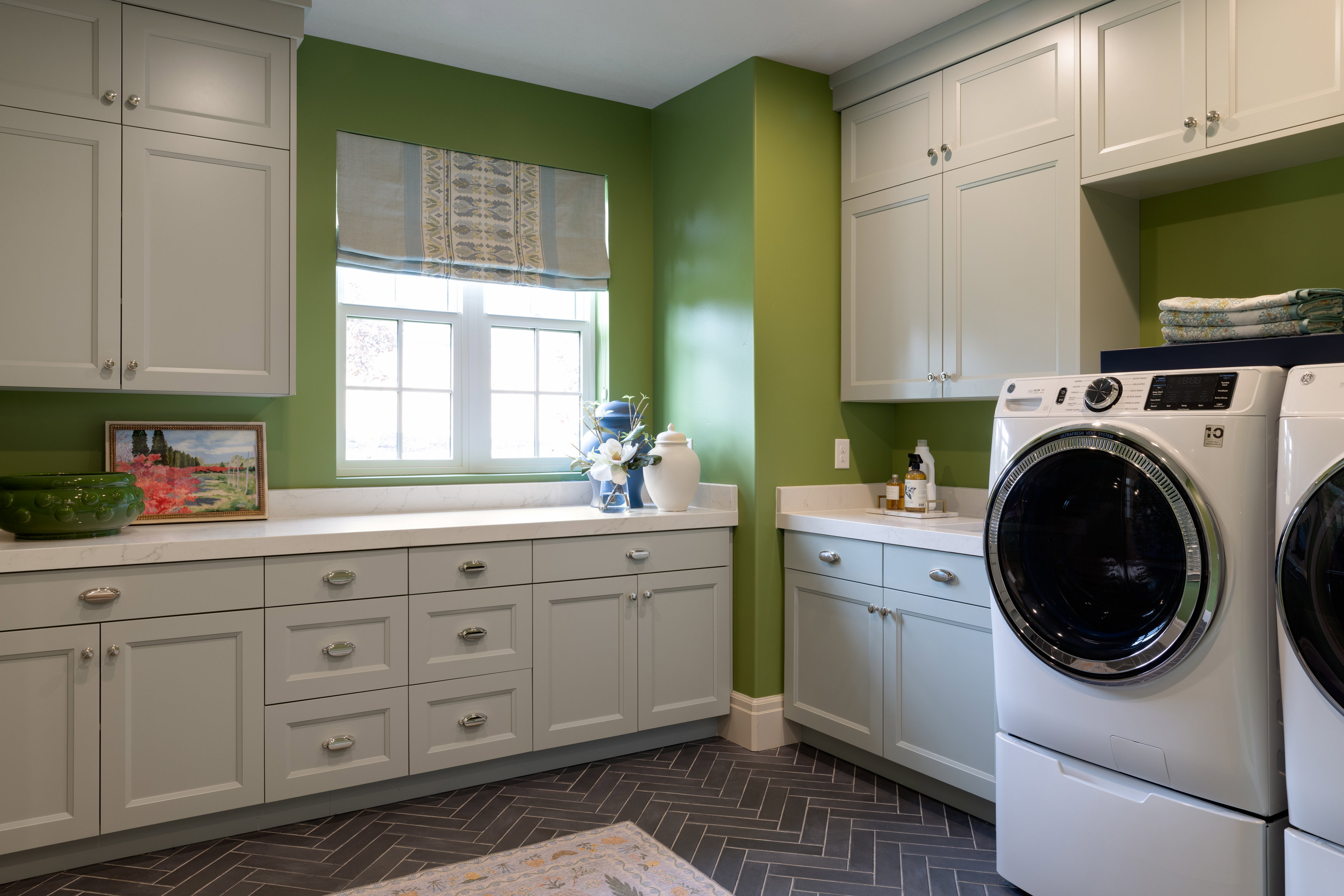 Laundry room featuring separate washer and dryer and cabinet space