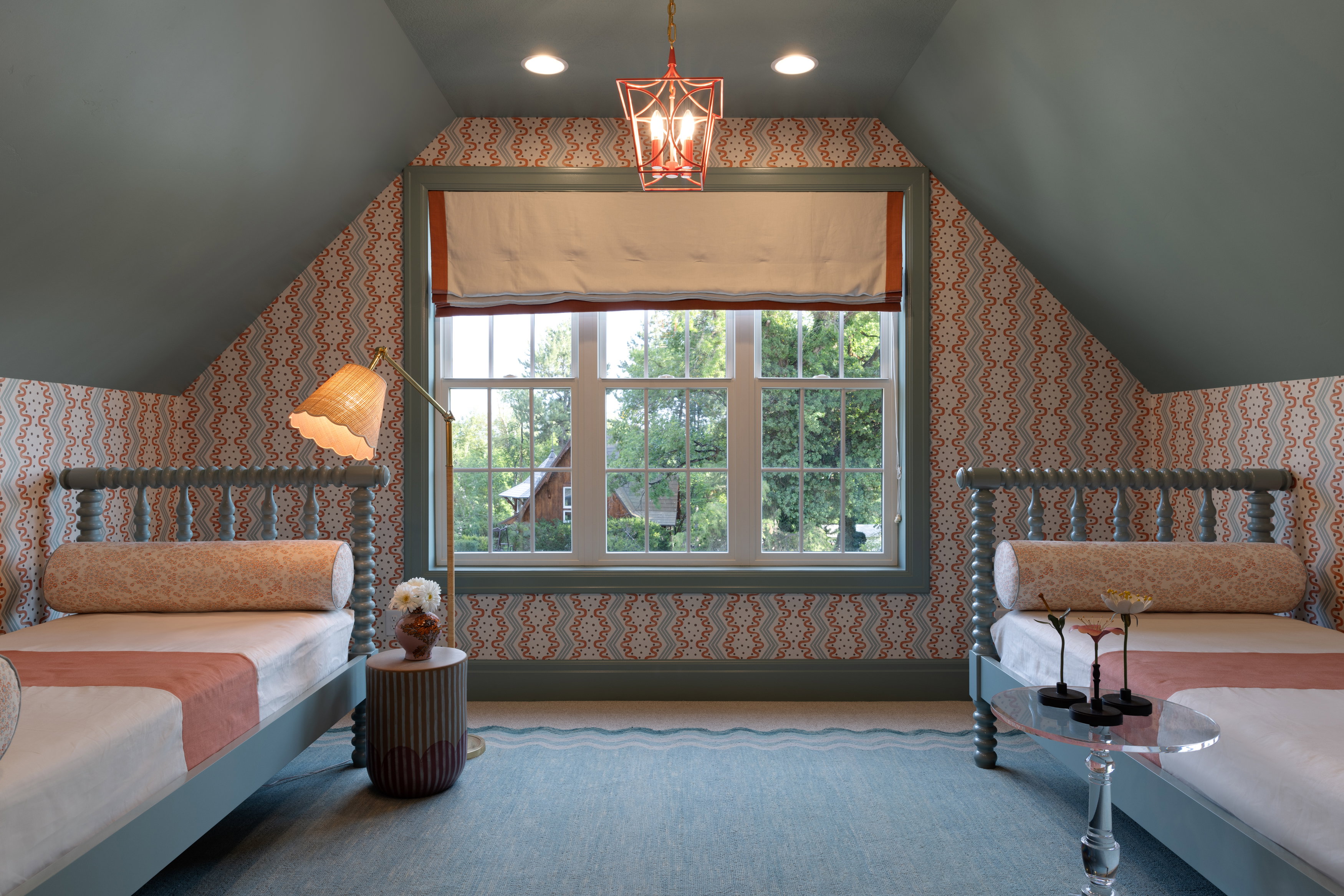 Carpeted bedroom with lofted ceiling, wallpapered walls, and a chandelier