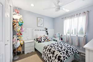 Carpeted bedroom featuring ceiling fan and recessed lighting