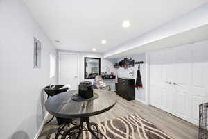 Dining area with light wood-type flooring, recessed lighting, and electric panel