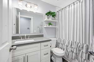 Full bathroom featuring vanity and curtained shower