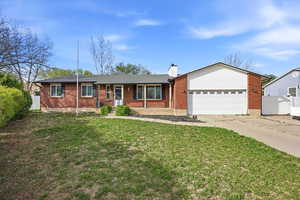 Ranch-style home with brick siding, a garage, concrete driveway, a chimney, and a porch
