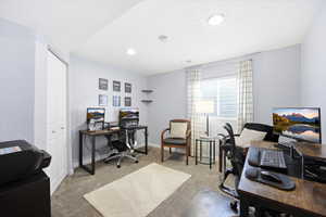 Office space featuring light colored carpet and recessed lighting