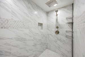 Full bath with a tile shower