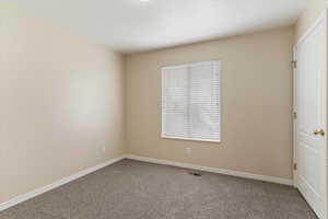 Unfurnished room with carpet floors and baseboards