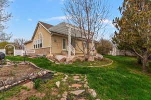 View of side of home featuring stucco siding, brick siding, and a patio