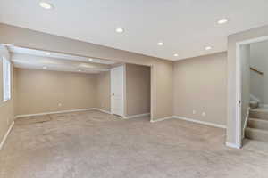 Basement featuring light colored carpet and recessed lighting