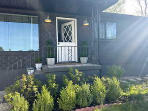 View of exterior entry featuring covered porch