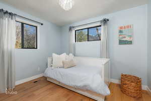 Bedroom featuring light wood-style floors and baseboards