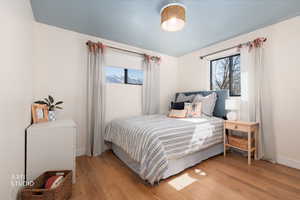 Bedroom featuring light wood-style flooring and baseboards