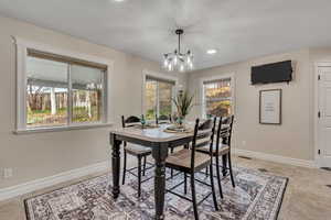 Dining space featuring a textured ceiling and a chandelier