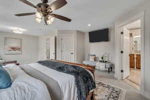 Primary Carpeted bedroom with ensuite bath, a ceiling fan, and recessed lighting