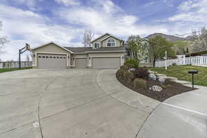 View of front of property featuring stucco siding, driveway, roof with shingles, and an attached garage