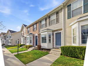 Colonial home with a residential view and a front yard