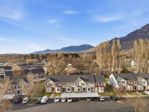 Aerial perspective of suburban area featuring a mountain backdrop