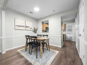 Dining area featuring baseboards and dark wood-style floors