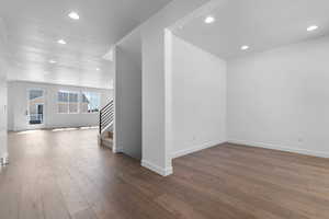 Unfurnished room with recessed lighting and dark wood-type flooring