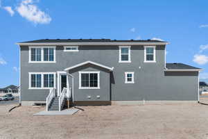 Rear view of house with stucco siding